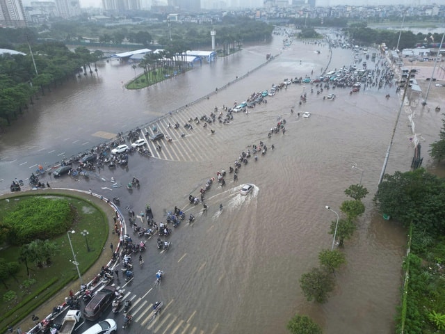 Người Hà Nội kiên nhẫn vượt ngập đến công sở- Ảnh 4.