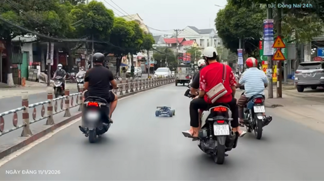 Phạt thanh niên vừa đi xe máy vừa điều khiển ô tô mô hình trên phố- Ảnh 1. Phạt thanh niên vừa đi xe máy vừa điều khiển ô tô mô hình trên phố- Ảnh 1.