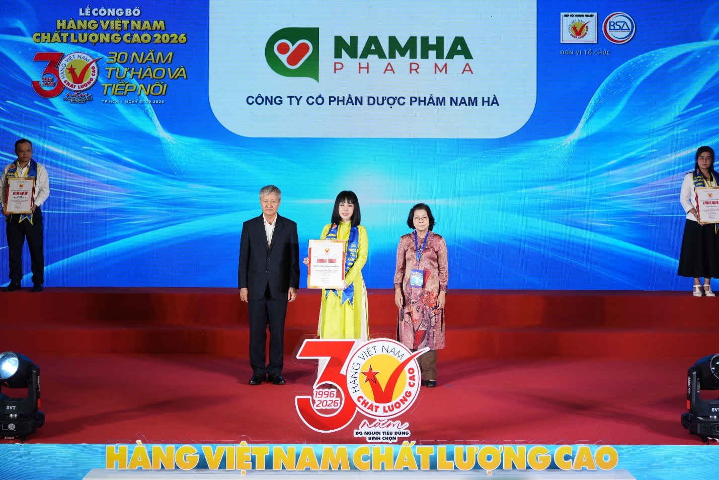 A group of people standing on a stage  Description automatically generated