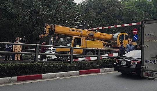Xe cẩu 'chui' không lọt cầu vượt Thái Hà, húc đổ thanh hạn chế chiều cao, xe máy bị vạ lây