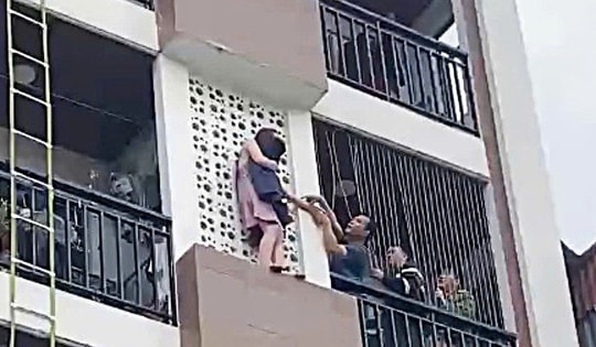 Kịp thời giải cứu cô gái trèo ra ngoài nhà cao tầng ở Tây Hồ